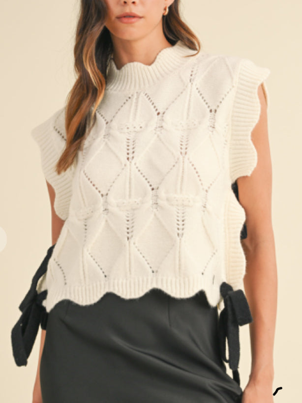 CABLE KNIT SCALLOPED VEST WITH CONTRAST SIDE BOW